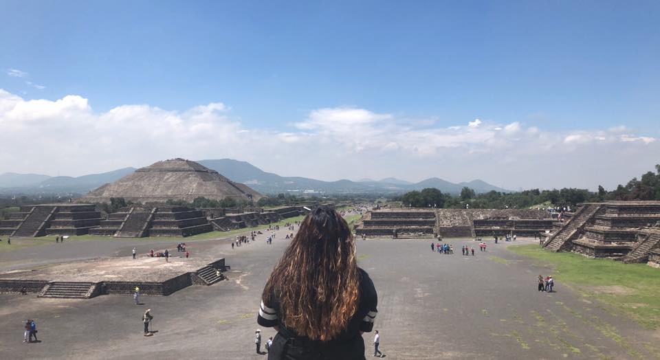 Student gazes into the distance at Mexican pyramids