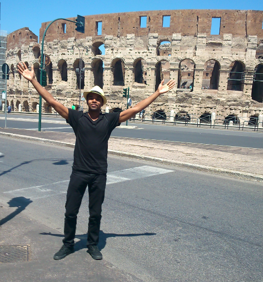 Kenny standing in front of an ancient structure